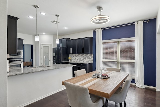 dining area featuring visible vents, baseboards, and dark wood finished floors