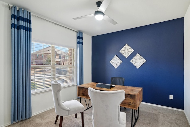 dining space with an accent wall, plenty of natural light, carpet, and ceiling fan