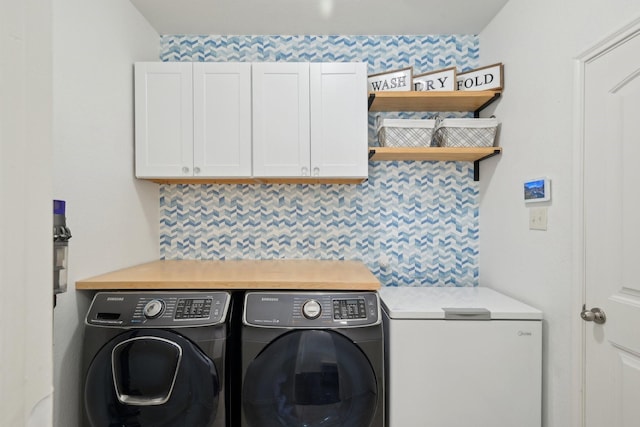 laundry area with cabinet space and separate washer and dryer