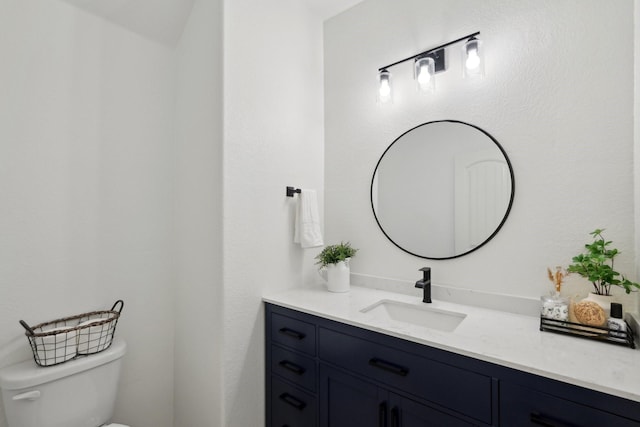 half bathroom featuring toilet and vanity