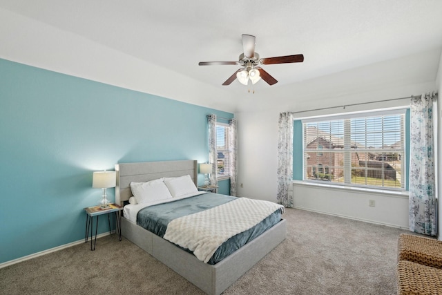 carpeted bedroom featuring baseboards and ceiling fan