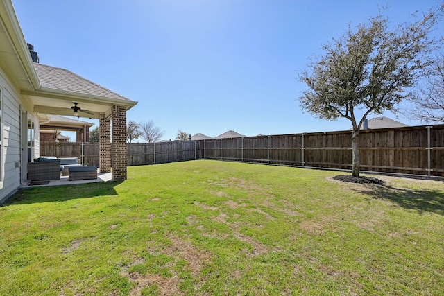 view of yard with ceiling fan and a fenced backyard