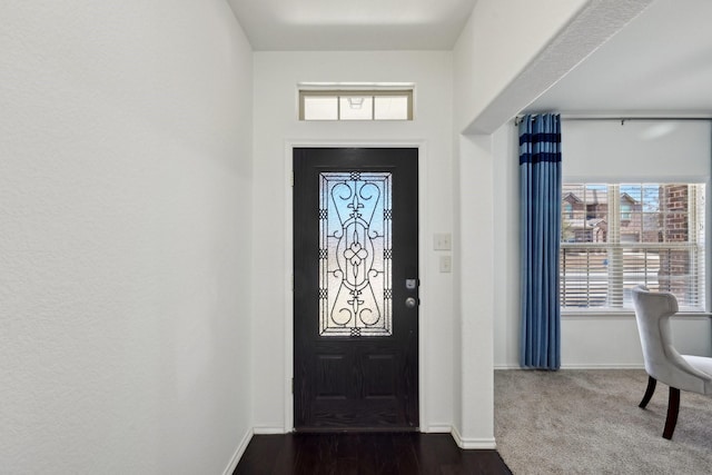 entryway featuring dark wood-type flooring and baseboards