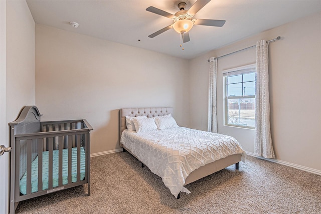 carpeted bedroom featuring baseboards and a ceiling fan