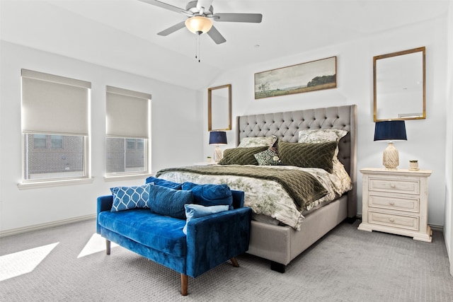 bedroom with baseboards, light colored carpet, a ceiling fan, and lofted ceiling