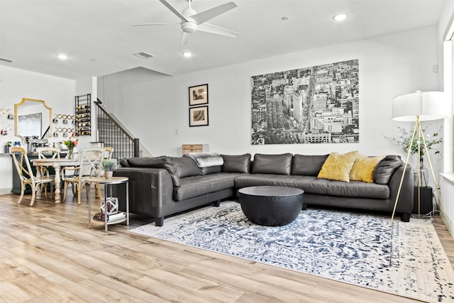 living room featuring a ceiling fan, stairway, recessed lighting, and wood finished floors