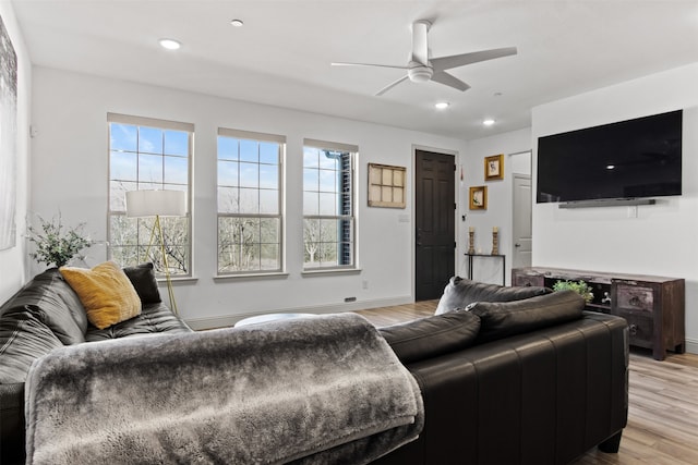 living area with plenty of natural light, recessed lighting, and light wood-style floors