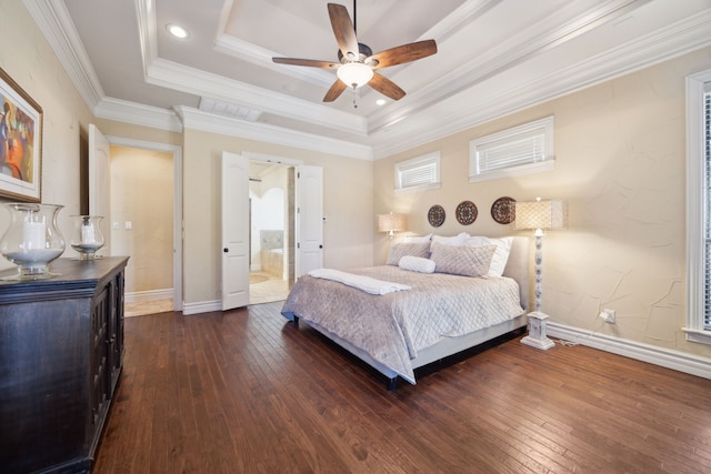 bedroom featuring baseboards, a raised ceiling, hardwood / wood-style floors, and ornamental molding