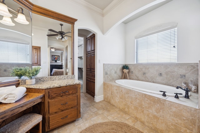 full bathroom with ceiling fan, ensuite bath, a bath, and ornamental molding