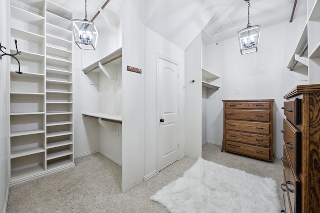 spacious closet featuring an inviting chandelier