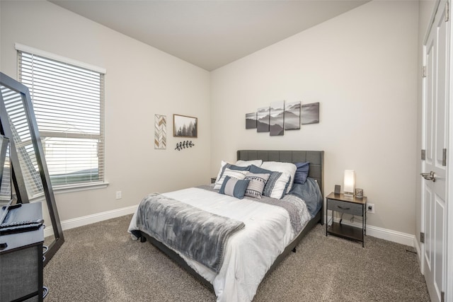 carpeted bedroom featuring baseboards