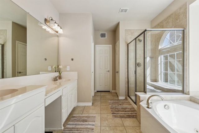 bathroom with a shower stall, a garden tub, double vanity, tile patterned floors, and a sink