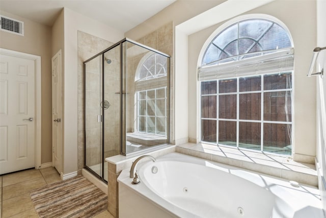 full bathroom featuring visible vents, a tub with jets, a stall shower, and tile patterned flooring