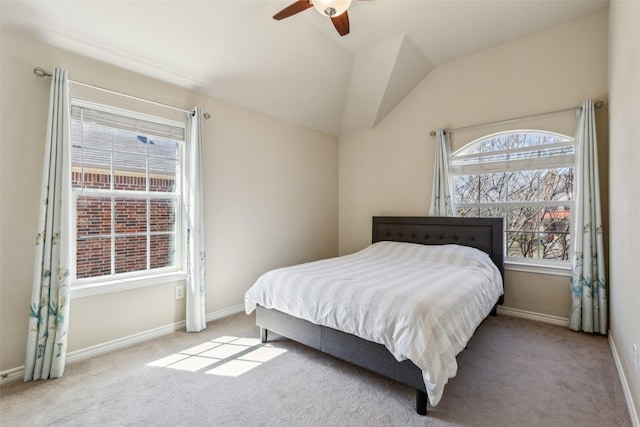 carpeted bedroom featuring baseboards, lofted ceiling, and ceiling fan