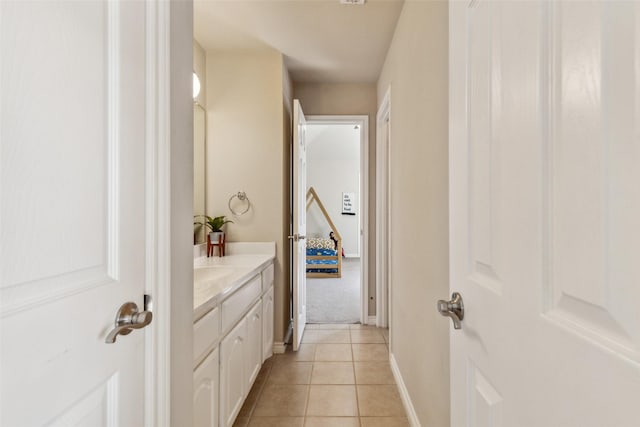 bathroom with vanity, tile patterned floors, and baseboards