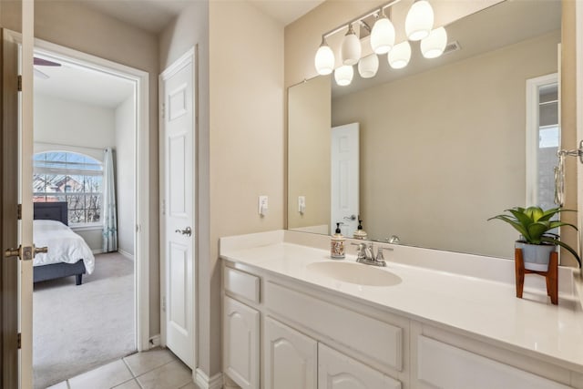 ensuite bathroom featuring vanity, tile patterned floors, and connected bathroom