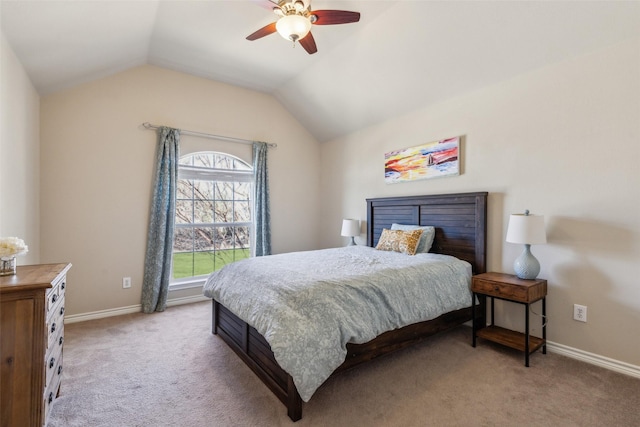 bedroom featuring light colored carpet, baseboards, lofted ceiling, and a ceiling fan