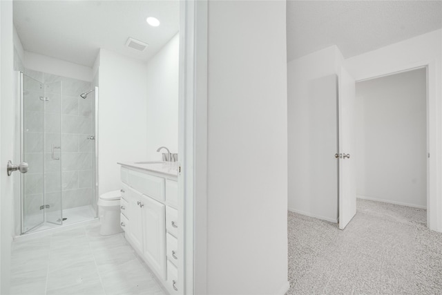 full bathroom with visible vents, toilet, a stall shower, and vanity