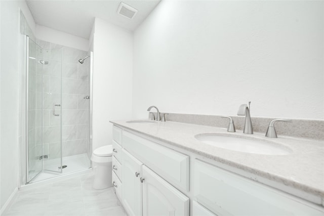 full bathroom with a shower stall, toilet, and a sink