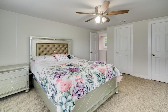bedroom featuring carpet flooring, baseboards, visible vents, and ceiling fan