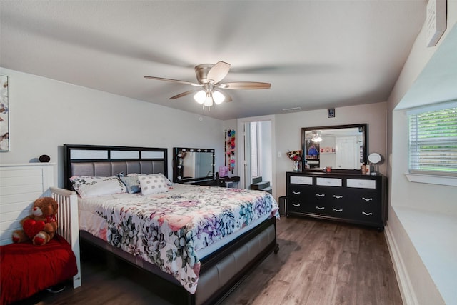 bedroom featuring a ceiling fan, wood finished floors, and visible vents