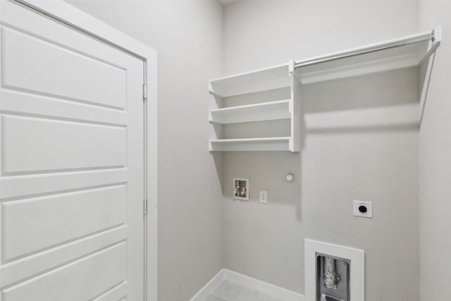 clothes washing area featuring baseboards, gas dryer hookup, washer hookup, laundry area, and hookup for an electric dryer