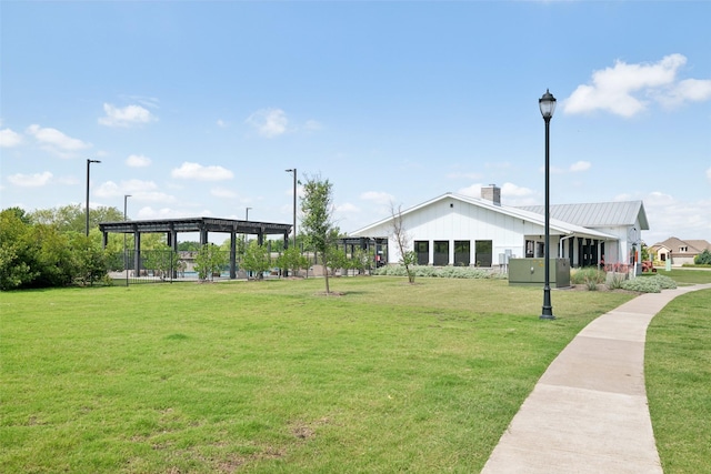 surrounding community with a lawn and a pergola