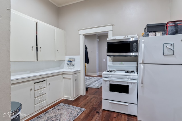 kitchen with backsplash, dark wood-type flooring, light countertops, white cabinets, and white appliances