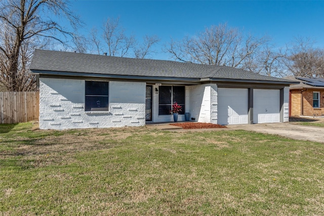 ranch-style house featuring a front yard, concrete driveway, fence, and an attached garage