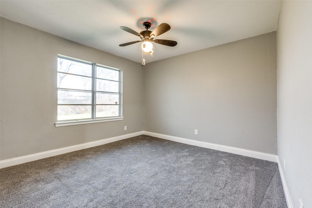 empty room with baseboards, a ceiling fan, and dark carpet