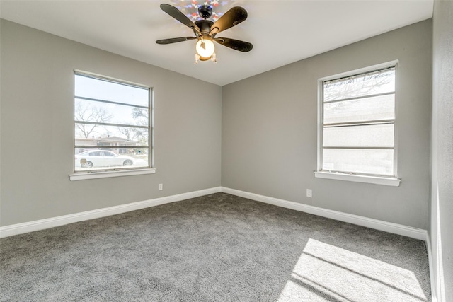 carpeted spare room with baseboards and ceiling fan