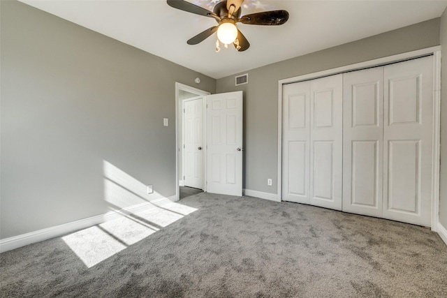 unfurnished bedroom featuring carpet flooring, baseboards, visible vents, and a closet