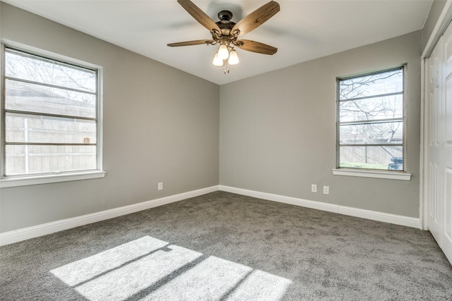 empty room with carpet, baseboards, and ceiling fan