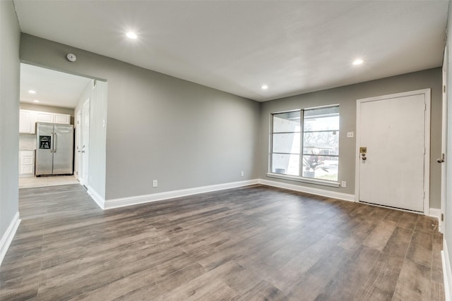 interior space featuring recessed lighting, baseboards, and wood finished floors