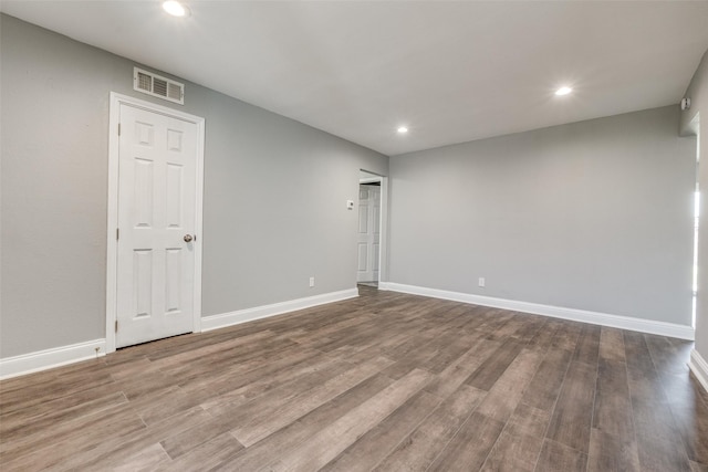 empty room with recessed lighting, visible vents, baseboards, and wood finished floors