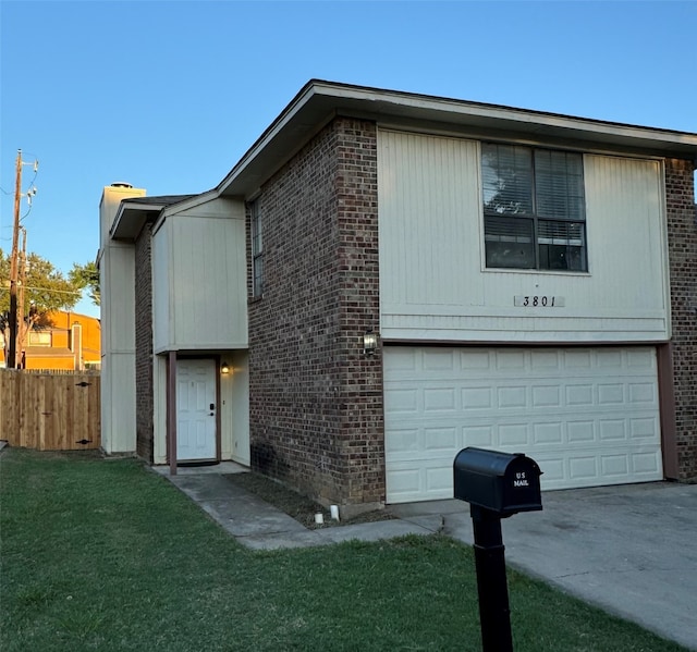 view of front facade with brick siding, a front lawn, fence, a garage, and driveway