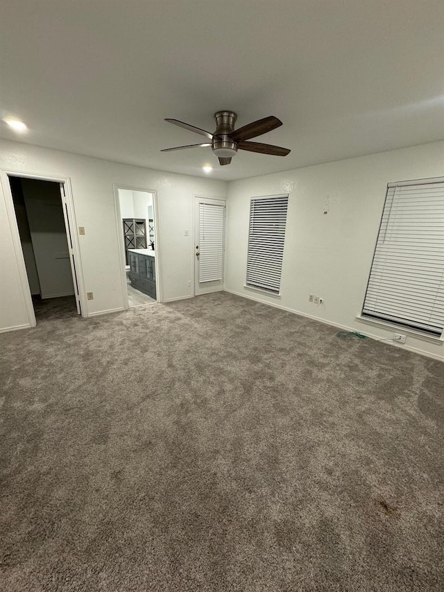 interior space featuring baseboards, carpet, and a ceiling fan