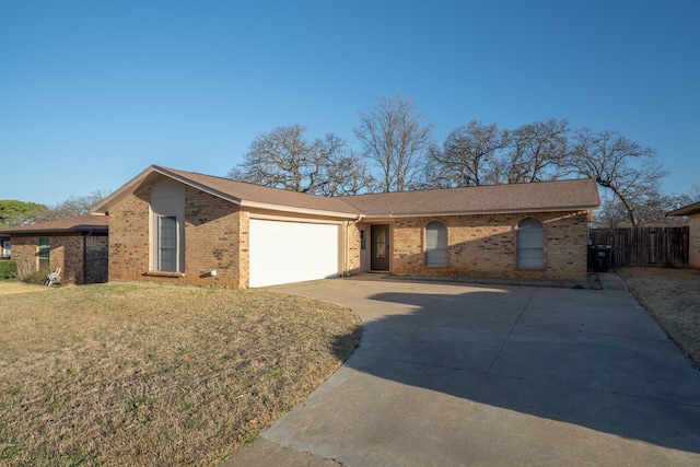 ranch-style house featuring brick siding, a front lawn, fence, driveway, and an attached garage