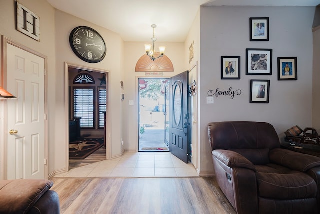 entrance foyer with an inviting chandelier and light wood-style floors