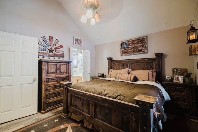 bedroom featuring a ceiling fan, wood finished floors, visible vents, high vaulted ceiling, and connected bathroom