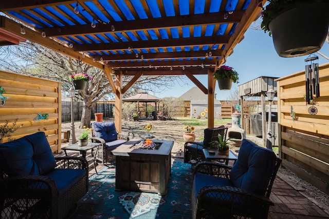 view of patio featuring an outdoor living space with a fire pit, a gazebo, a fenced backyard, and a pergola