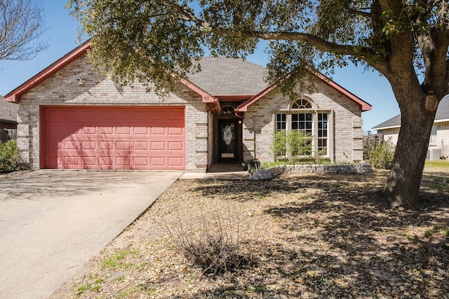 ranch-style home featuring brick siding, driveway, a shingled roof, and a garage