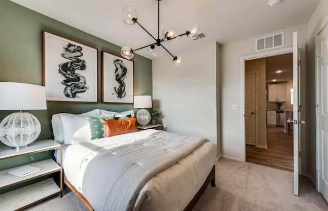 bedroom with visible vents, baseboards, carpet, and a notable chandelier