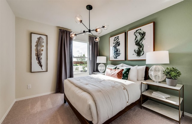 carpeted bedroom with baseboards and an inviting chandelier