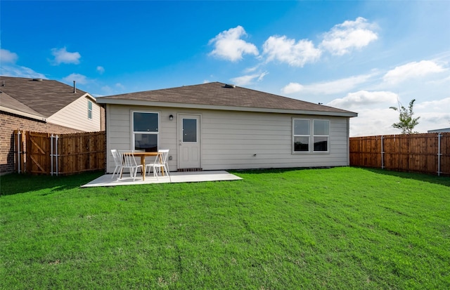 rear view of house with a patio area, a lawn, and a fenced backyard