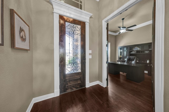 foyer with a wealth of natural light, baseboards, a ceiling fan, and dark wood-style flooring