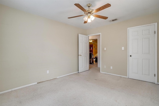 unfurnished bedroom featuring carpet flooring, baseboards, visible vents, and ceiling fan