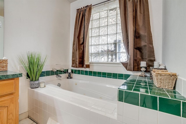 full bathroom featuring a jetted tub and vanity