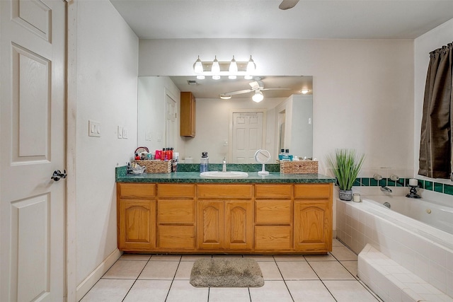 full bath with tile patterned flooring, vanity, a ceiling fan, and a whirlpool tub