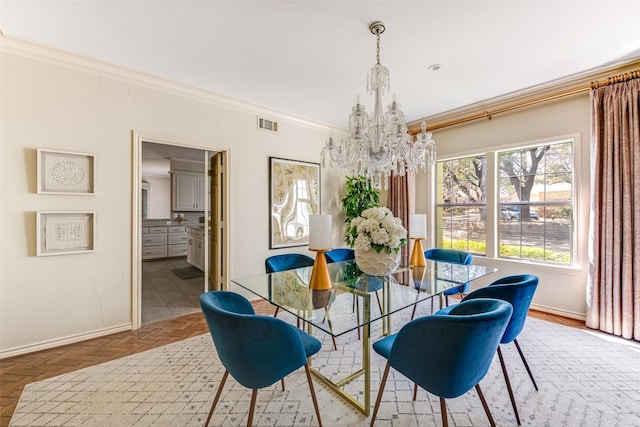 dining room featuring an inviting chandelier, visible vents, baseboards, and ornamental molding